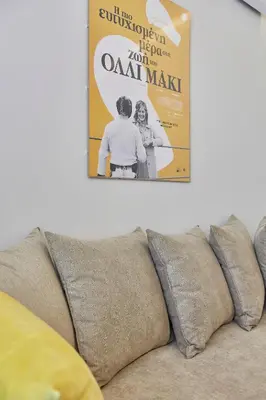 a poster hanging on a wall above a couch at Old Athens style 1bdr with Acropolis view rooftop! in Athens