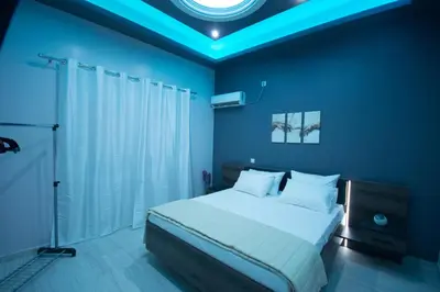 a bedroom with a large bed with a blue ceiling at ARETI in Athens