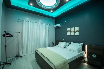a bedroom with a large bed with a blue ceiling at ARETI in Athens