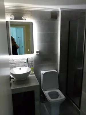 a bathroom with a toilet and a sink and a mirror at ARETI in Athens