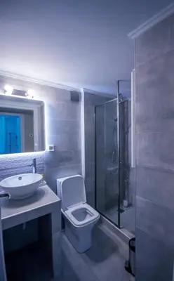 a bathroom with a toilet and a sink and a shower at ARETI in Athens