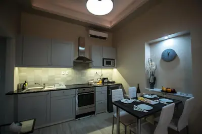 a kitchen with a table and a kitchen with a dining room at ARETI in Athens