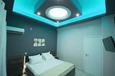 a bedroom with a bed with a blue ceiling at ARETI in Athens