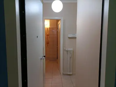 a hallway leading to a bathroom with a shower at The Urban Escape in Athens
