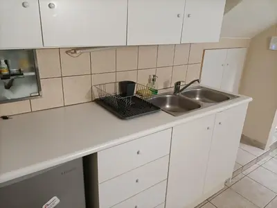 a kitchen counter top with a sink and a sink at The Urban Escape in Athens