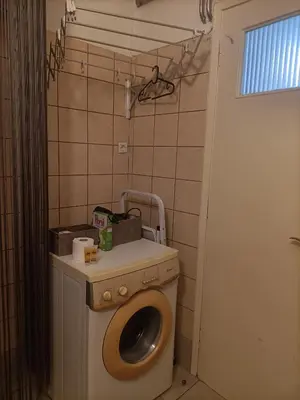a bathroom with a washing machine and a toilet at The Urban Escape in Athens