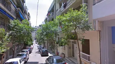 a city street with cars parked on the street at The Urban Escape in Athens