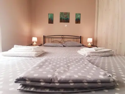 two twin beds in a bedroom with two lamps at Ilias' cosy and relaxing apartment in Athens