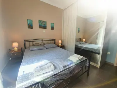 a bedroom with a bed and a large mirror at Ilias' cosy and relaxing apartment in Athens