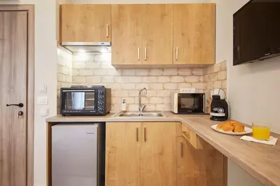 a small kitchen with a sink and a microwave at Stay in a hip decorated studio near Acropolis! in Athens