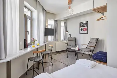 a room with chairs and a desk and a bed at Explore Athens like a movie star, near Acropolis! in Athens