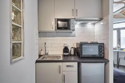 a kitchen with a sink and a microwave at Explore Athens like a movie star, near Acropolis! in Athens