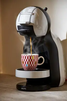 a coffee maker is pouring coffee into a cup at Explore Athens like a movie star, near Acropolis! in Athens