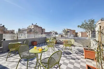 a patio with chairs and tables on a balcony at Explore Athens like a movie star, near Acropolis! in Athens