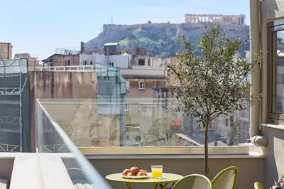 a table with a plate of food on top of a window at Explore Athens like a movie star, near Acropolis! in Athens
