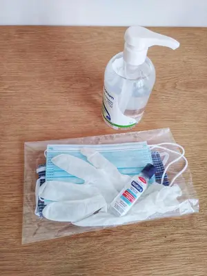 a plastic bag with a bottle of mouthwash and a pair of gloves at Explore Athens like a movie star, near Acropolis! in Athens
