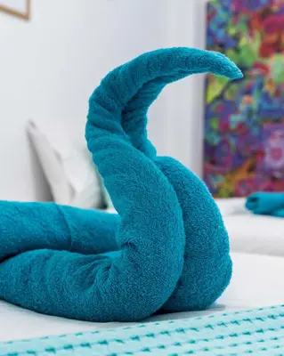 a blue towel animal sitting on a table at Koukaki Olympiou Apartment in Athens