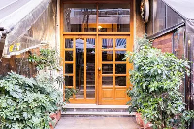 an entrance to a building with a wooden door at Koukaki Olympiou Apartment in Athens