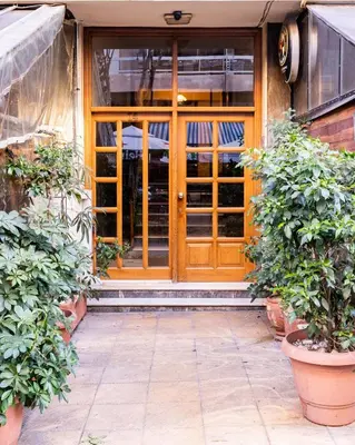 an entrance to a building with a wooden door at Koukaki Olympiou Apartment in Athens