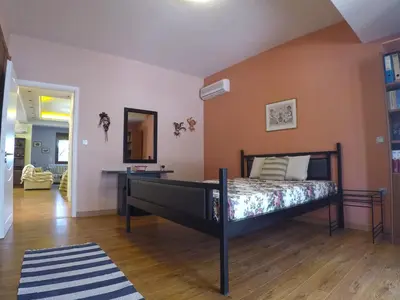 a bedroom with a bed in the middle of a room at Luxury Villa with Private Pool in Keratea