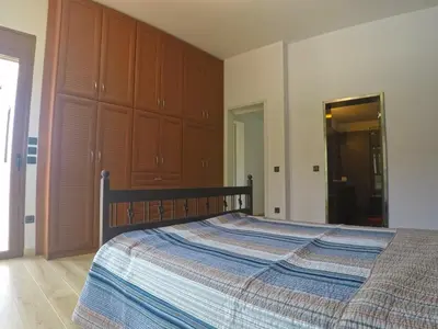 a bedroom with a large bed with a wooden headboard at Luxury Villa with Private Pool in Keratea