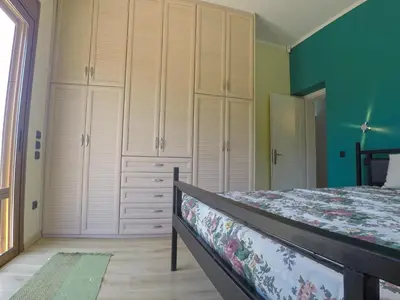 a bedroom with a bed and some white cabinets at Luxury Villa with Private Pool in Keratea
