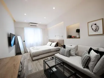 a living room with a couch and a bed at Downtown Syntagma apartment 1 in Athens