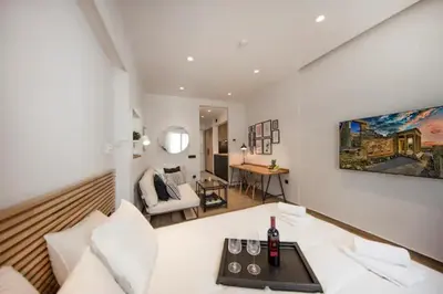 a room with a bed and a living room at Downtown Syntagma apartment 1 in Athens