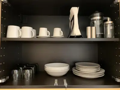 a shelf with plates and cups and dishes in a kitchen at Downtown Syntagma apartment 3 in Athens