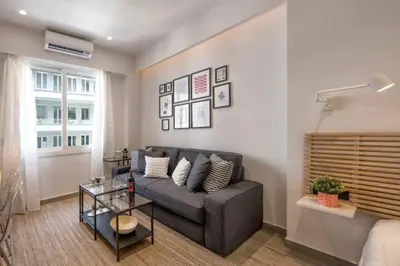 a living room with a couch and a table at Downtown Syntagma apartment 3 in Athens