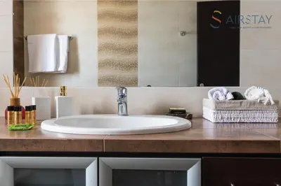 a bathroom counter with a sink and a mirror at Thresh Apartments Airport by Airstay in Spáta