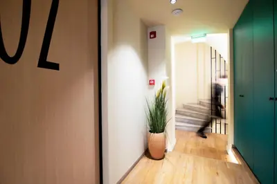 a hallway with a plant in a vase on the floor at Still Athens in Athens