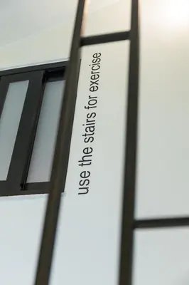 a sign on the side of a window with the word excellence at Still Athens in Athens