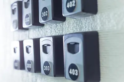 a row of black and white remote controls on a wall at Still Athens in Athens
