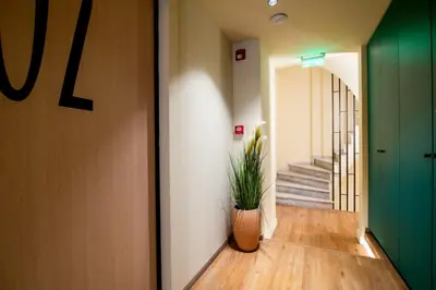 a hallway with a plant in a vase on the floor at Still Athens in Athens