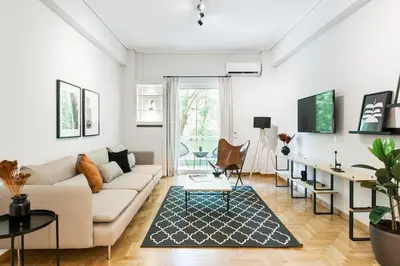 a living room with a couch and a table at Bright 2BD Apartment in Psychiko by UPSTREET in Athens