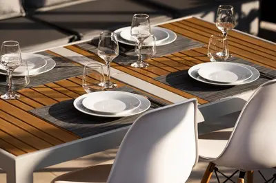 a wooden table with plates and wine glasses on it at Athens View Loft 07 & 08 in Athens