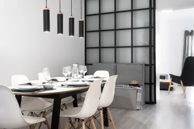 a dining room with a table and white chairs at Athens View Loft 07 & 08 in Athens