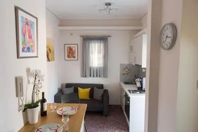 a small living room with a couch and a table at ivannas penthouse in Athens
