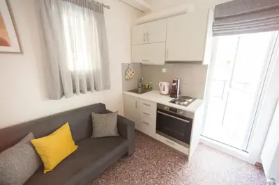 a living room with a couch and a kitchen at ivannas penthouse in Athens