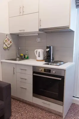 a small kitchen with a stove and a sink at ivannas penthouse in Athens