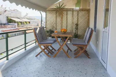 a table and two chairs sitting on a balcony at ivannas penthouse in Athens