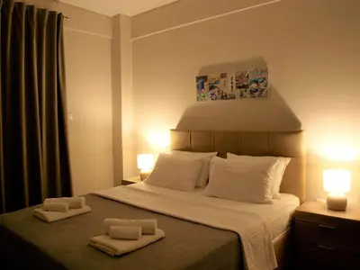 a bedroom with a bed with two towels on it at Anna's Relaxing Dreamhouse in Athens