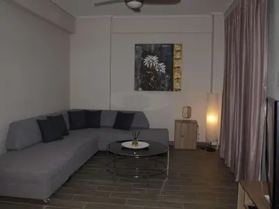 a living room with a couch and a table at Anna's Relaxing Dreamhouse in Athens