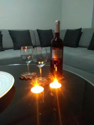 a bottle of wine and two wine glasses on a table at Anna's Relaxing Dreamhouse in Athens
