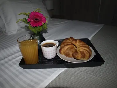 a tray with a plate of bread and a cup of coffee at Anna's Relaxing Dreamhouse in Athens