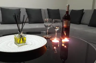 a bottle of wine and two wine glasses on a table at Anna's Relaxing Dreamhouse in Athens