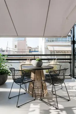 a patio with a table and chairs on a balcony at *** Boutique Syntagma apartment w/ plunge pool *** in Athens