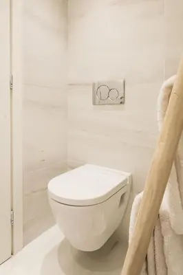 a white bathroom with a toilet and towels at *** Boutique Syntagma apartment w/ plunge pool *** in Athens
