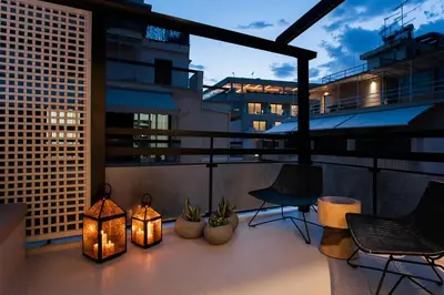 a balcony with lights and chairs on a building at *** Boutique Syntagma apartment w/ plunge pool *** in Athens